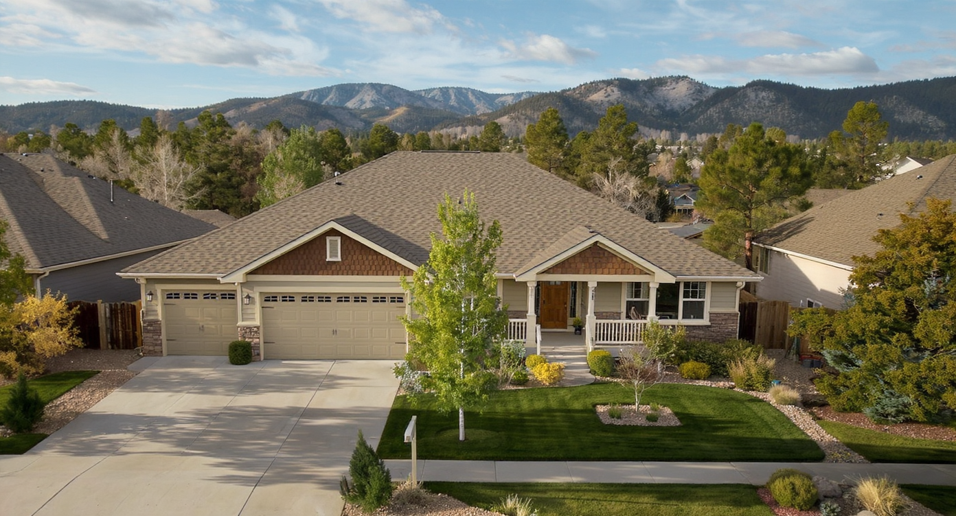 Well-maintained architectural shingle roof on a suburban home in Falcon, Colorado, with clean gutters and the Front Range behind